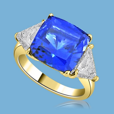 Sapphira - Fantastic Ring with a plush 4 Ct. Cushion Cut Sapphire Essence Masterpiece that highlights by each side of Trilliant accents.6 Cts. t.w. in 14K Solid White Gold, to chase your blues away!
