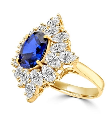 Designer ring with 3.5 Ct. oval Sapphire Essence set in four prongs, and surrounded by pear cut diamond essence stones in floral pattern. 8.5 Cts. T.W. et in 14K Solid Yellow Gold.