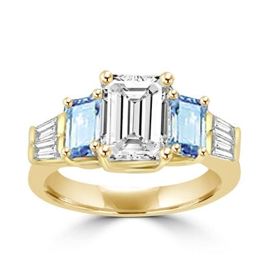 Classic Wide Ring with a 2 Ct. Emerald Cut Brilliant Masterpiece in the center, saluted on each side by a 0.5 ct. Emerald Cut Aquamarine Stone and clear white Baguette Masterpieces further down. 3.5 Cts. T.W, in 14K Solid Gold.