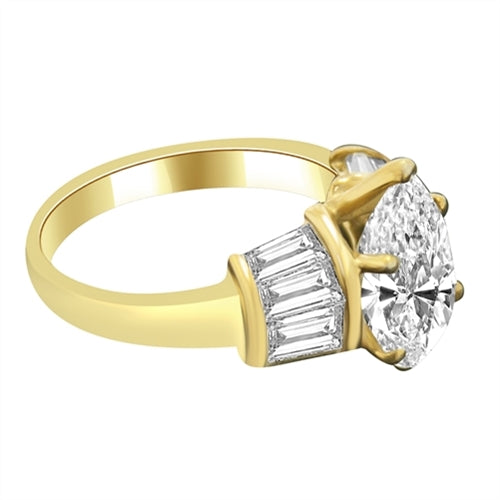 Majestic Pear cut Diamond Essence ring. 3 carat Pear center encircled by baguettes accents on either side. 5.0 cts.t.w. in 14K Solid Gold.