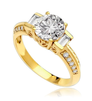 You will surly be pleased with this stunning new design. 2 Ct. Round Brilliant Diamond Essence Masterpiece is accentuated by channel baguettes and round melee on band. Ethnic carving on band makes this a uniquely adorable piece to collect. 2.75 Cts. T.W.