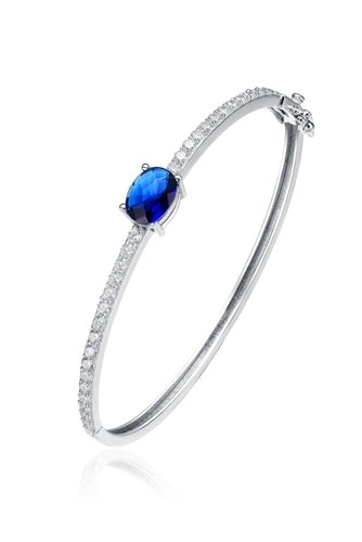 Bangle Bracelet - 2.0 Cts.Oval cut Sapphire Essence set in center with sparkling Diamond Essence Melee going around the Bangle, 4.0 Cts.T.W. set in Platinum Plated Sterling Silver.