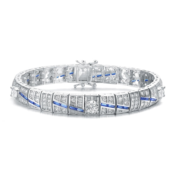 A stunner, this Platinum Plated Sterling Silver 7.25" bracelet features five round brilliant stones, 0.5 cts each, joined by melee and sapphire baguettes . 14.0 cts. T.W.