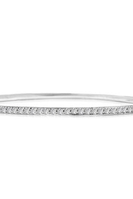 An alluring prong-set slip-on bangle bracelet for women with simulated round brilliant Diamonds by Diamond Essence set in platinum plated sterling silver. 4.50 Cts.t.w.