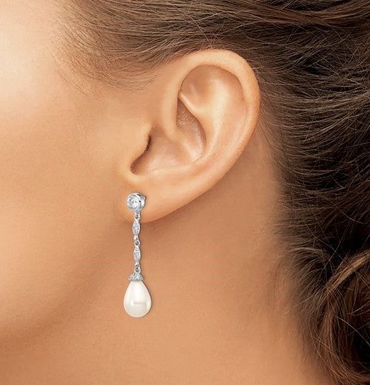 Diamond Essence Designer Earring with round brilliant melee and 8mm Pearl. Perfect for all occasions, 1.40 cts. t.w. in Platinum Plated Sterling Silver.