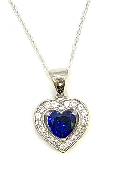 Heart shape Sapphire Essence stone in prong setting, is surrounded by round brilliant Diamond Essence stones, making another heart. 2.5 cts.t.w. in Platinum Plated Sterling Silver.