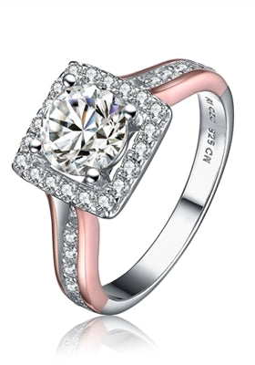 Diamond Essence Designer Ring in two tone.Center stone 1 ct. surrounded by Diamond Essence melee in square shape. 1.25 Cts. T.W. Ring is Platinum Plated Sterling Silver & rose gold plated over sterling silver. Approx dimension of square around center diam