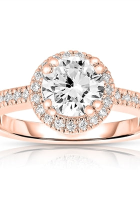 Diamond essence Designer Ring, with 1 carat Round Brilliant center stone set in artistic basket setting, surrounded by melee. Band with melee enhances the beauty, in Rose Gold Plated Sterling Silver.