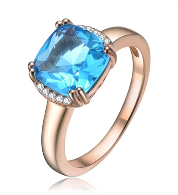 Diamond Essence Designer Ring with 2.5 carat Aquamarine Cushion Essence in 8 prongs setting and delicate melee set on two sides of cushion essence for additional beauty.2.60 Cts.T.W. in Rose Plated Sterling Silver.