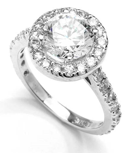 Diamond Essence Halo Setting Designer Ring With 2 Cts. Round Center and Melee around And On The Band, 4.50 Cts.T.W. In Platinum Plated Sterling Silver.