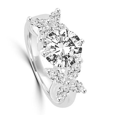 Unusual Ring with a 2.0 Ct. Round Brilliant cut Diamond Essence center stone supported by a vibrant "X" on each side with 8 Marquise Cut Masterpieces. 3.2 Cts. T.W, in Platinium Plated Sterling Silver