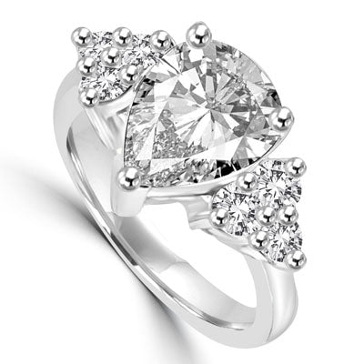 Blinding Beauty - She'll adore this outsized 2 Ct. Pear Shaped white Brilliant Diamond Essence masterpiece set with 3 dazzling round stones on either side of the band. Outstanding value for 2.30 Cts. T.W. in Platinum Plated Sterling Silver.