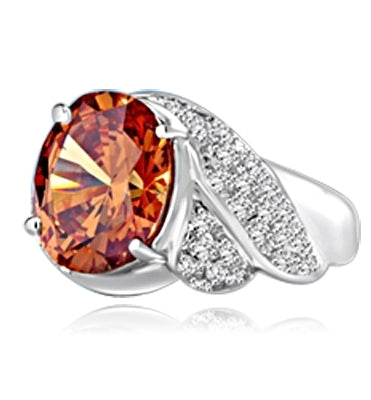 Platinum Plated Sterling Silver ring, with a large oval 6.0 cts. Diamond Essence champagne stone at the center flanked by melees on a twisted shank, 7.50 cts. T.W.