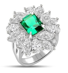 Diamond Essence classic cocktail ring. 2.5 Ct. Radient Emerald cut Emerald Essence surrounded by marquise cut and pear cut Diamond Essence in floral setting. 11.0 cts.T.W. set in Platinum Plated Sterling Silver.