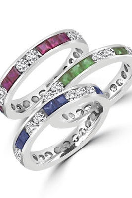 Best selling Eternity Bands with Princess Cut simulated Emeralds and Round Cut Diamond Essence stones all around the band. 1.5 Cts. T.W, in Platinum Plated Sterling Silver.