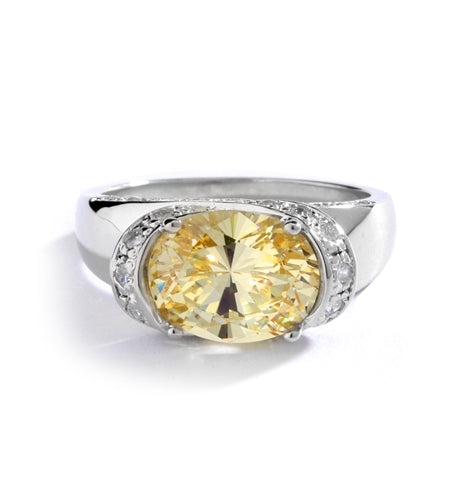 East West Ring- Oval cut Canary Essence set in center with Melee set on side setting going around in criss cross design from center, down the side of the band. 3.25 Cts T.W. set Platinum Plated Sterling Silver.