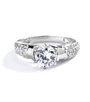 Engagement Ring- Tiffany set, 1.0 Ct Round Brilliant Diamond Essence in center with cluster of sparkling Melee on the band. 1.25 Cts T.W. set in Platinum Plated Sterling Silver.