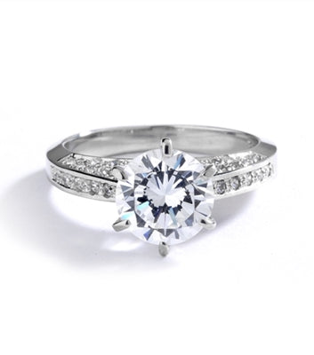 Diamond Essence Designer Ring with 2.0 Cts. Round Brilliant Diamond Essence in Center and melee set on three sides of band, 3.90 Cts. T.W. set in Platinum Plated Sterling Silver.