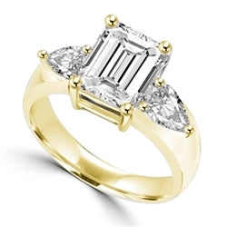 Brilliant Ring with 3 carat Radient Emerald Diamond Essence with 0.5 carat Pear cut Diamond Essence on each side. 4.0 cts.t.w. in Gold Vermeil.