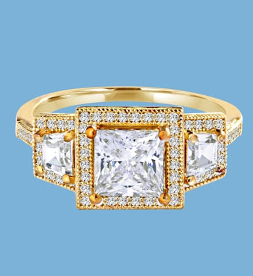 Diamond Essence Ring with 1.5ct. Princess Cut stone set in four prongs with baguettes on each side surrounded by round stones, 2.5ct.T.W. set in 14K Gold Vermeil.