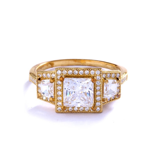 Diamond Essence Ring with 1.5ct. Princess Cut stone set in four prongs with baguettes on each side surrounded by round stones, 2.5ct.T.W. set in 14K Gold Vermeil.