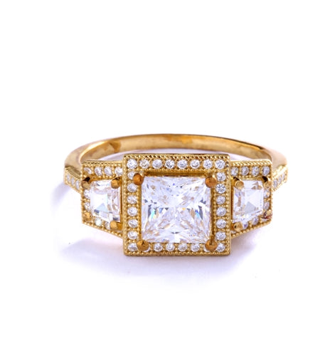 Diamond Essence Ring with 1.5ct. Princess Cut stone set in four prongs with baguettes on each side surrounded by round stones, 2.5ct.T.W. set in 14K Gold Vermeil.