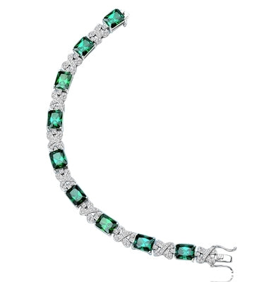 A stunner, this 14K Solid White Gold 7" bracelet features nine radiant-cut Emerald stones, 3.0 cts each, joined by stylish ribbons of melee. 29.0 cts. T.W.