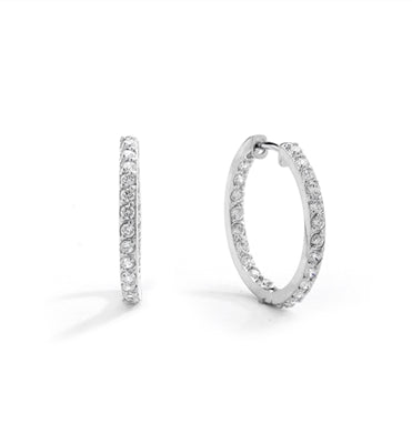 Classic 14K Solid White Gold hoop earrings with a melee of Round cut Diamond Essence stones orbiting all around your delicate lobes. These highly flattering hoops are also hinged half way around so they can go on and come off in a flash. 2.0 cts.t.w.