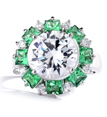Classic Designer Ring with 3.0 Cts. Round Brilliant Diamond Essence Stone in the center, surrounded by 0.5 Ct. each, Green Princess cut stones and round stones. Round melee set on band, makes it more artistic. 9.50 Cts.T. W. set in 14K Solid White Gold.