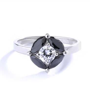 Ring - round-cut diamond is surrounded by marquise-cut black onyx