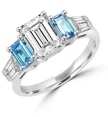 Classic Wide Ring with a 2 Ct. Emerald Cut Brilliant Masterpiece in the center, saluted on each side by a 0.5 ct. Emerald Cut Aquamarine Stone and clear white Baguette Masterpieces further down. 3.5 Cts. T.W, in 14K Solid White Gold.