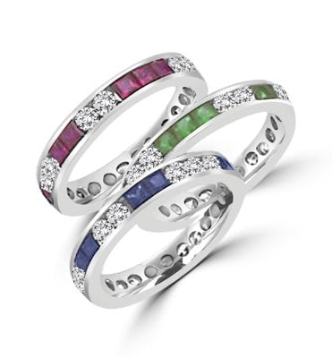 Best selling Eternity Bands with Princess Cut simulated Emeralds and Round Cut Diamond Essence stones all around the band. 1.5 Cts. T.W, in 14K White Gold.