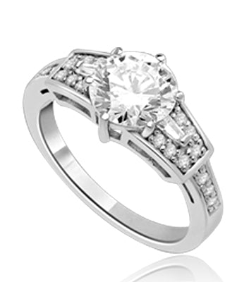 Mesmerizing 2.0 Ct Brilliant stone is adorned by superbly crafted Baguettes and Round Melee forming 2.5 Cts. T.W. In 14k Solid White Gold.