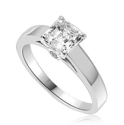 Diamond Essence Asscher cut Solitaire Ring artistically set in a wide band with a beautiful accent on both sides to enhance the looks. 1 ct.t.w. in 14K Solid White Gold.