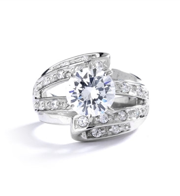 Abstract Art - 2.75 Cts. Round Brilliant Diamond Essence set high in center with Melee set abstract design flowing underneath center to halfway down the band.3.25 Cts. T.W. set in 14K Solid White Gold.