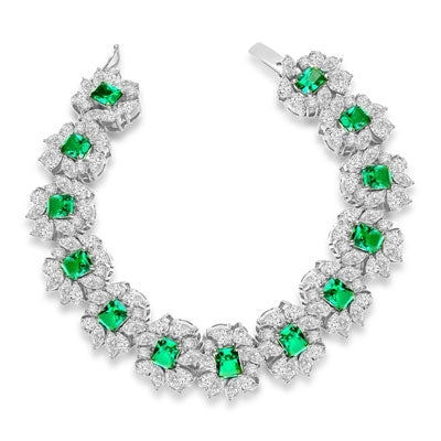 7" long Diamond Essence Bracelet with Emerald cut 13 Emerald Essence,each 1ct, surrounded by Marquie, Pear and Round stones. Appx. 38.0 Cts. T.W. set in platinum Plated Sterling Silver.
