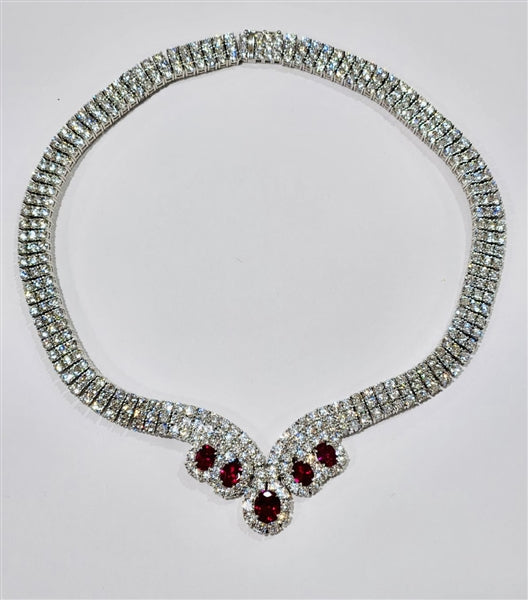 Magnificent Ruby Necklace. 3.0 Cts. Oval cut Ruby Essence in the center and 1.50 Cts. each Ruby Essence encircled by Diamond Essence stones. making 3 rows all around neckline. Special lock- on clasp to secure it. Just perfect to make any day a special day