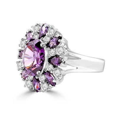 This designer ring is just perfect for party lovers to show-off. 3.0 ct. oval cut amethyst, surrounded by 8 small amethyst marquise,1.3 cts.and white round stones 0.80 cts. all around it, 5.10 cts T.W. set in Pltinum Plated Sterling Silver.