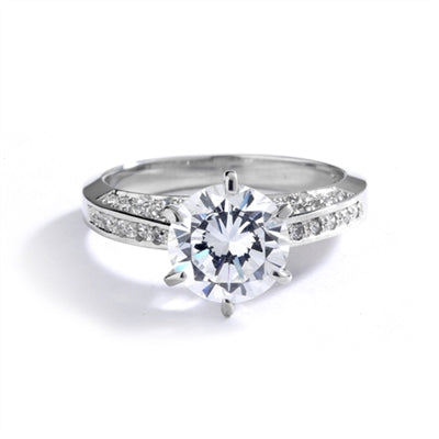 Diamond Essence Designer Ring with 2.0 Cts. Round Brilliant Diamond Essence in Center and melee set on three sides of band, 3.90 Cts. T.W. set in Platinum Plated Sterling Silver.