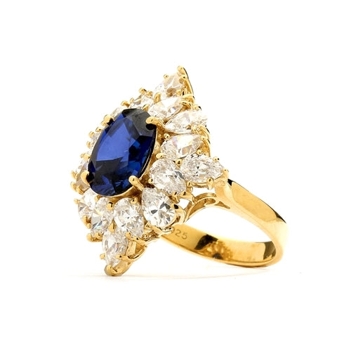 Designer ring with 3.5 Ct. oval Sapphire Essence set in four prongs, and surrounded by pear cut diamond essence stones in floral pattern. 8.5 Cts. T.W. set in 14K Gold Vermeil.