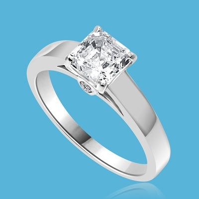 Diamond Essence Asscher cut Solitaire Ring artistically set in a wide band with a beautiful accent on both sides to enhance the looks. 1 ct.t.w. in 14K Solid White Gold.